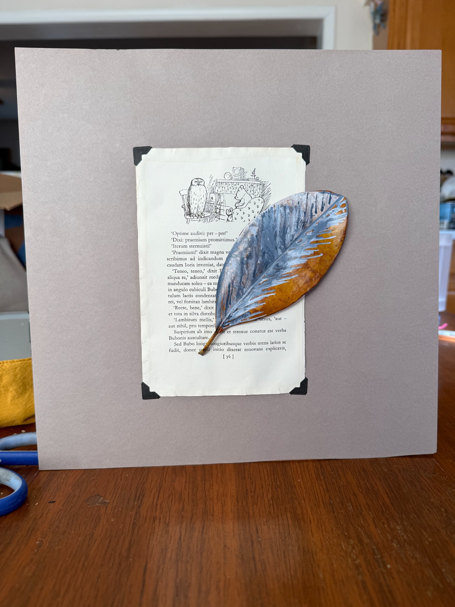 Bubo, painted magnolia leaf mounted over a found book page